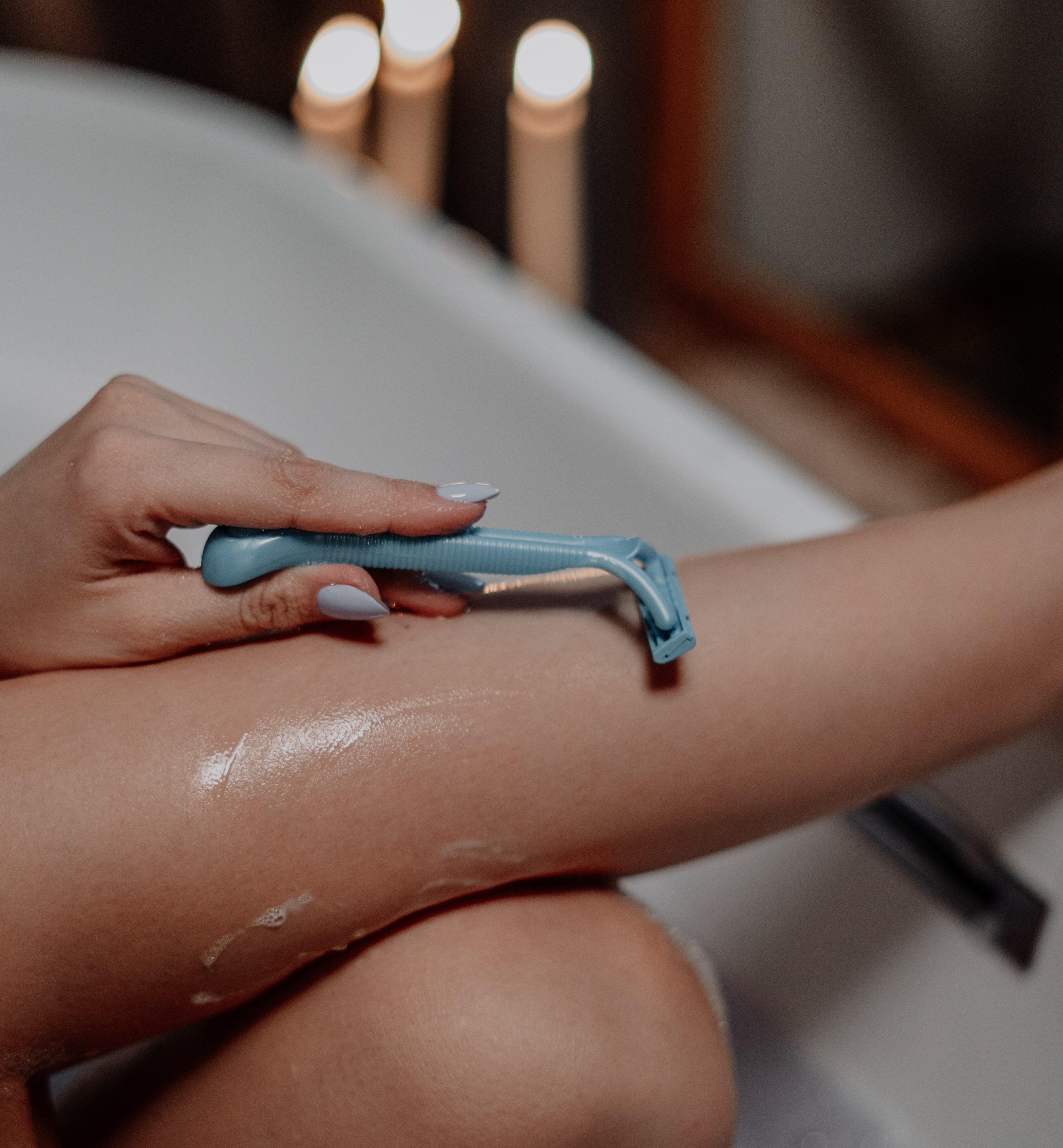 woman shaving in tub, castile soap uses